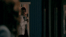 a man in a lab coat has a name tag on his chest that says ' dr. ' on it