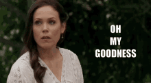 a woman says " oh my goodness " in front of trees
