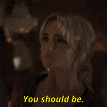 a woman says " you should be " in yellow