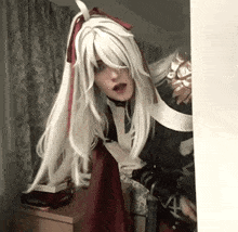 a woman in a white wig is standing in a room .