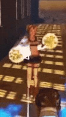 a blurred image of a woman standing on a pole