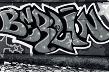 a black and white photo of graffiti on a wall with the letters b and e on it