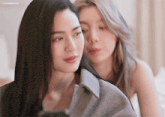 a blurred image of two women with the letters lm on the bottom