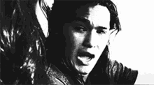 a black and white photo of a man with a tear running down his face .