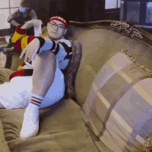 a person sitting on a couch wearing a headband that says illegal