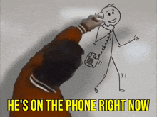 a man is drawing a stick figure on a wall with the words he 's on the phone right now