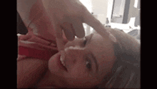 a man is touching a woman 's forehead while she is laying on a bed .