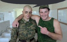 a man in a green tank top is pointing at another man in a camo shirt