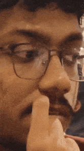 a close up of a man 's face with glasses