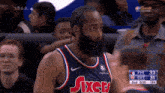 a man with a beard wearing a jersey that says sixers on it