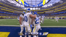 a group of football players are celebrating a touchdown on a field