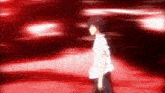 a man in a white shirt is walking in a dark room