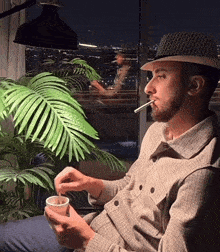 a man in a hat is smoking a cigarette
