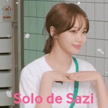 a woman in a white shirt with the words solo de sazi in red