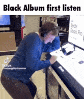 a man wearing headphones is looking at a beats studio pro