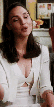 a woman wearing a white dress and a white jacket