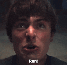a close up of a man 's face with his mouth open and the word run written below him