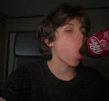 a person drinking a bottle of dr pepper