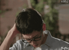 a close up of a man wearing glasses with kbs2 in the upper right corner