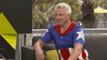 a man in a captain america costume is sitting on a couch