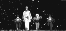 a black and white photo of three anime characters standing next to each other .