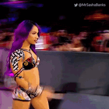 a woman with purple hair is standing in front of a crowd .