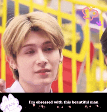 a man is obsessed with a beautiful man with a yellow fence in the background