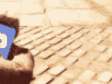 a blurry picture of a person laying on a brick floor with a phone in front of them .