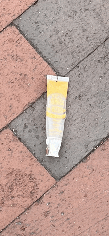 a tube of lip balm is on the ground