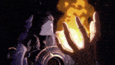 a close up of a person holding a fireball in their hands .