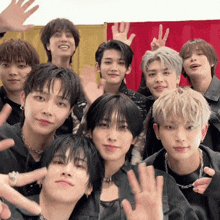 a group of young men are posing for a picture and one of them is wearing a necklace