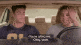 two men are sitting in a car and one of them is wearing a jersey with the number 11 on it