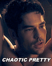 a close up of a man 's face with the words chaotic pretty below it