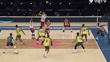 a group of volleyball players are playing a game and one player has the number 9 on their jersey