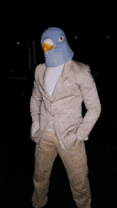 a man in a suit has a pigeon mask on his face