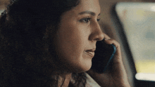 a close up of a woman talking on her cell phone