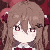 a close up of a girl 's face with a heart on her hair .