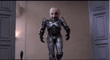 a man in a robot costume is standing in front of a door