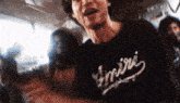a man wearing a black t-shirt with the word empire on it