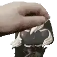 a close up of a person 's hand on top of a funko pop .