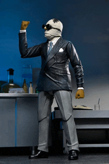 a figurine of a man in a suit with a mask on his head