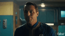 a man in a fallout uniform is smiling