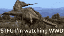 a picture of a dinosaur with the words stfu i 'm watching wwd above it
