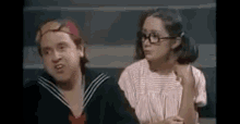 a man and a woman are sitting next to each other .