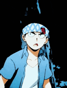 a man with a bandana on his head is wearing a blue shirt