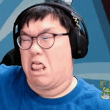 a man wearing headphones and glasses making a funny face