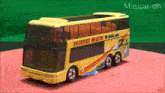 a toy double decker bus with the word mato on the side