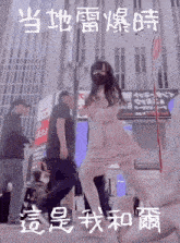 a girl in a pink dress is dancing in front of a sign that says ' a ' on it