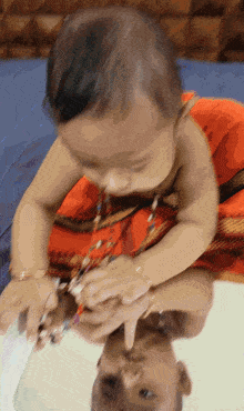 a baby is playing with a pair of scissors and his reflection is shown