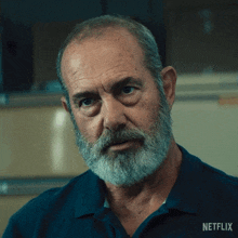 a man with a beard and a shirt that says netflix on it